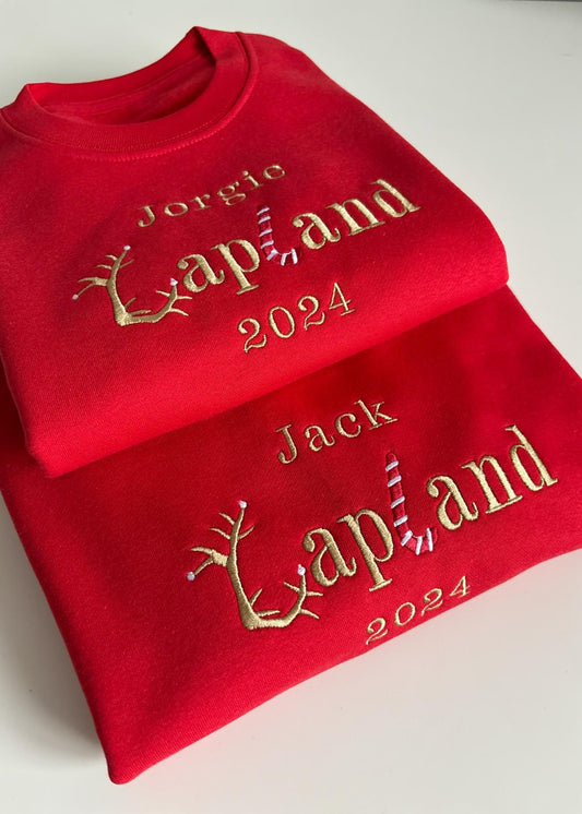Two red sweatshirts with golden text and reindeer graphics, one with 'Jorge' and the other with 'Jack' and the year '2024' printed on the front.