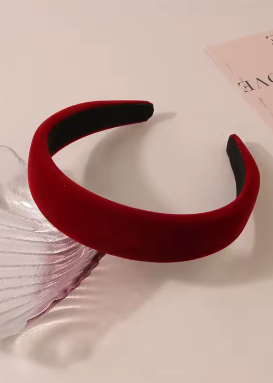 Red headband on a light pink background