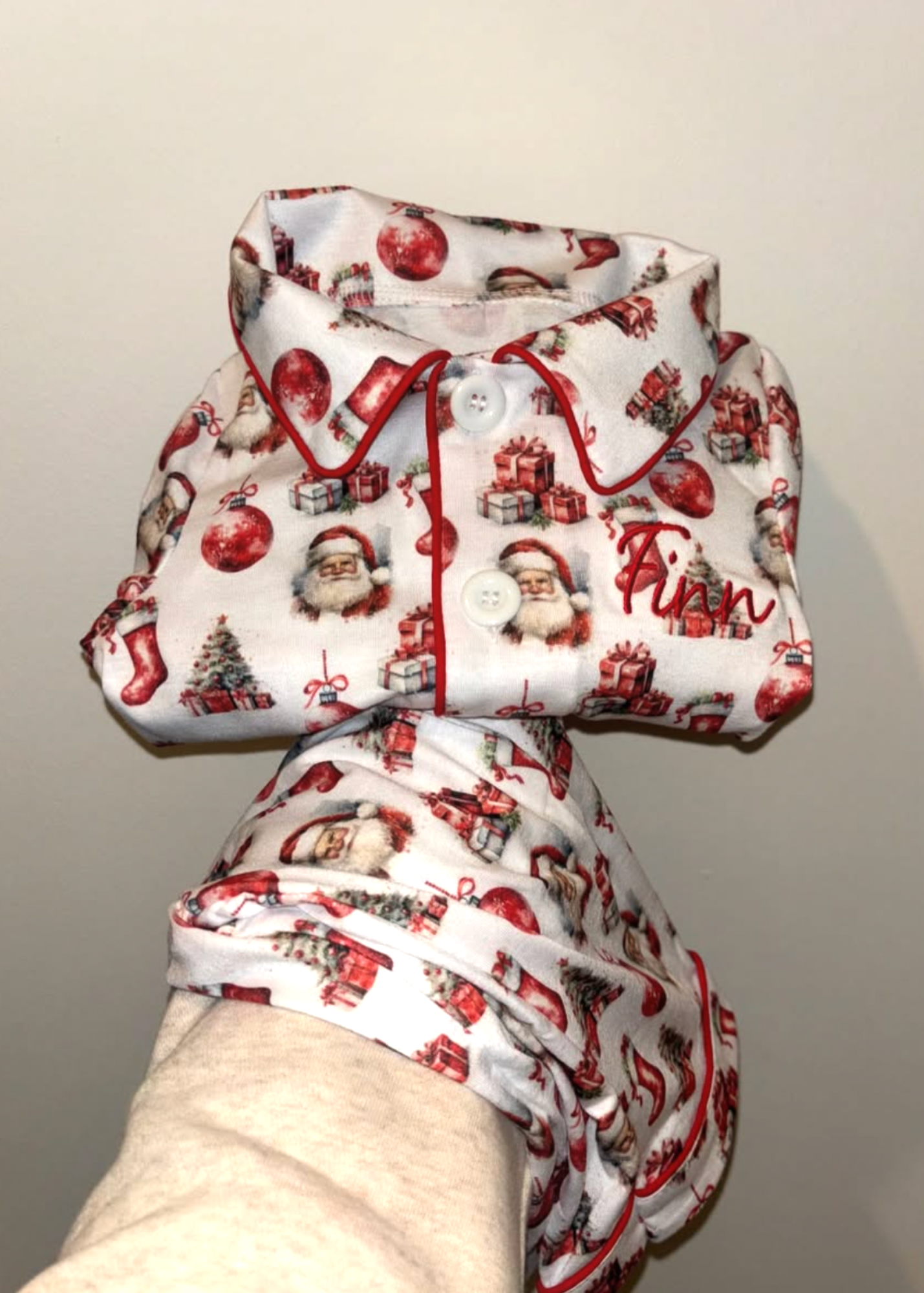 Christmas-themed baby outfit on a mannequin against a plain background