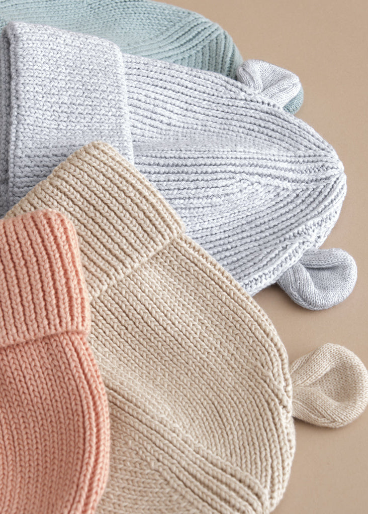 Knitted socks in pastel colors on a beige background