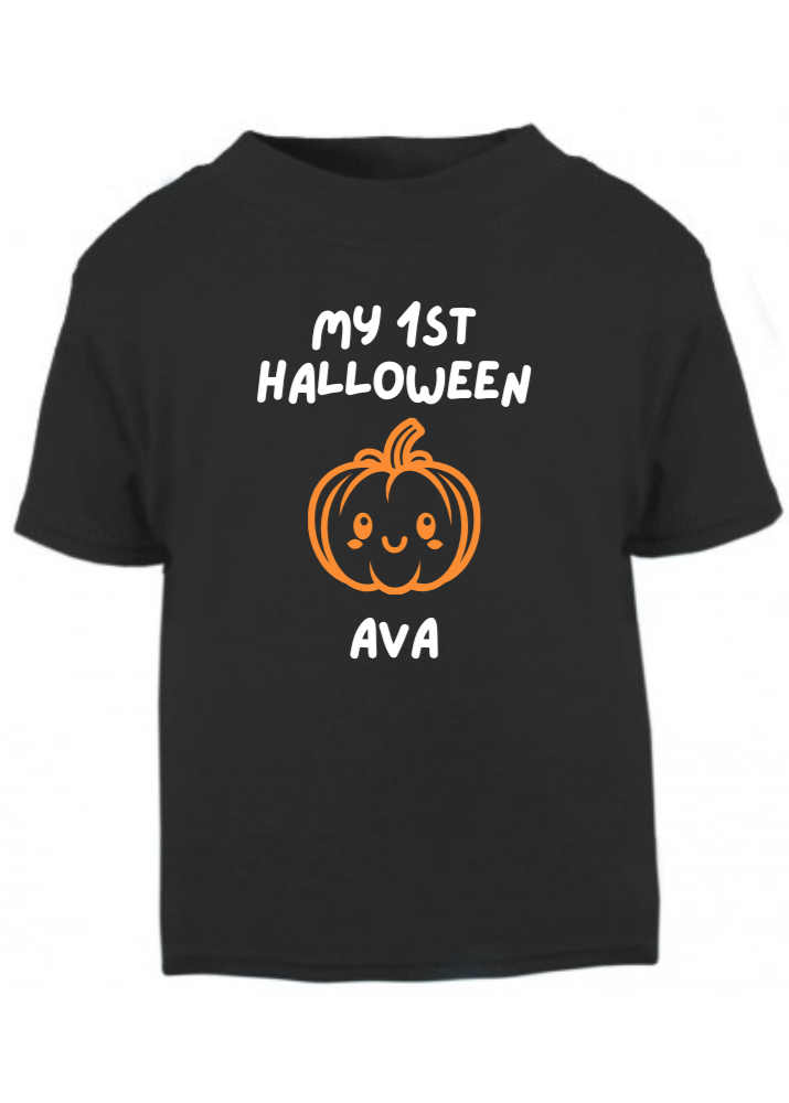 Black t-shirt with a pumpkin design and text for a child's first Halloween on a white background