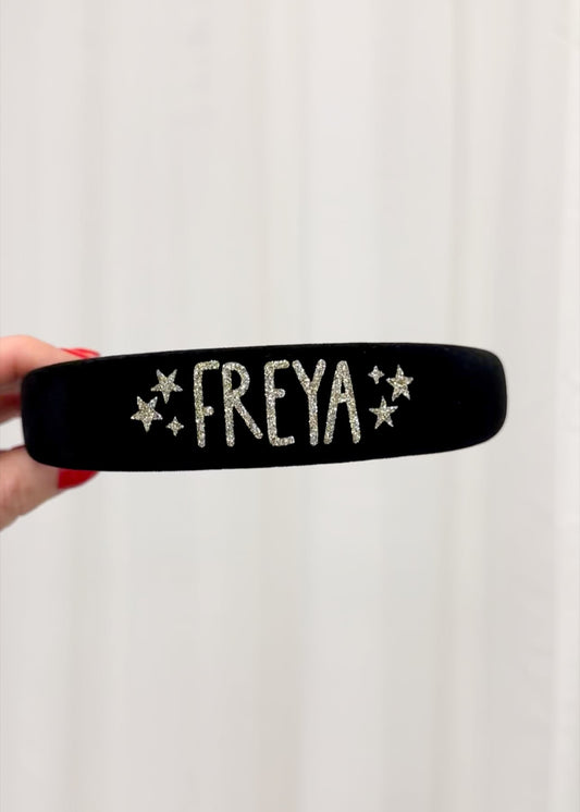Black headband with 'FREYA' text on a white background